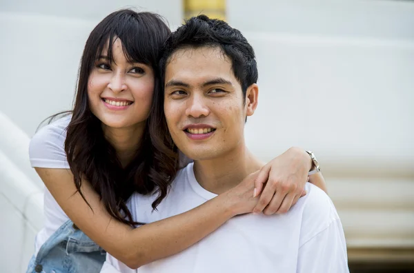 Lovely couple embrace on the stairs — Stock Photo, Image