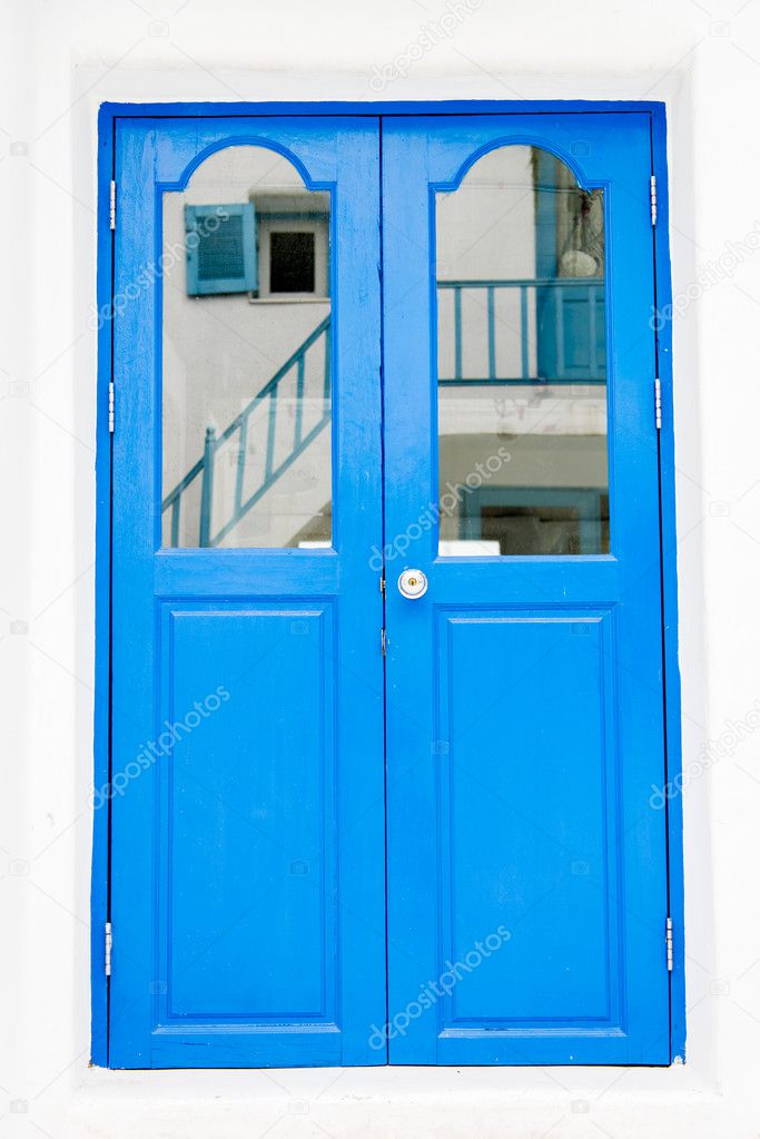 Blue wooden door on white wall