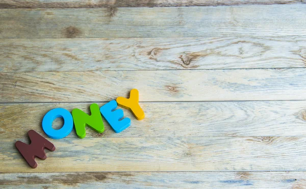 Colorful wooden word Money on wooden floor — Stock Photo, Image