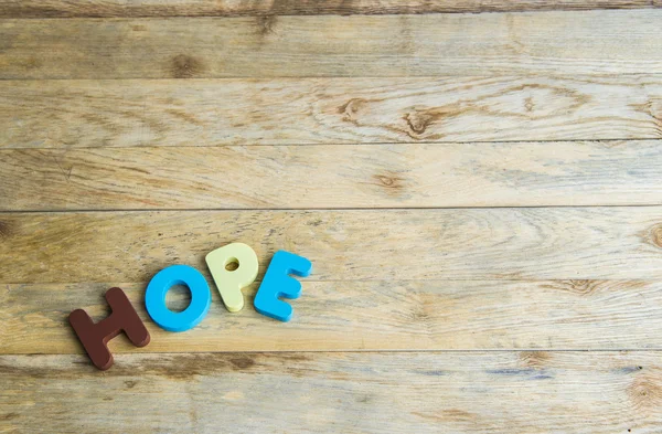 Colorful wooden word Hope on wooden floor — Stock Photo, Image