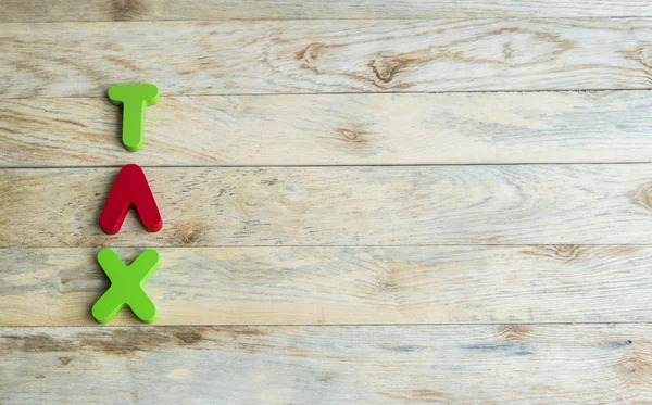 Kleurrijke houten woord belasting op houten floor4 — Stockfoto