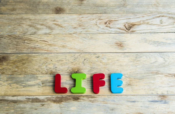 Colorful wooden word Life on wooden floor3 — Stock Photo, Image