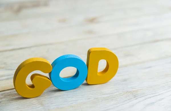 Palabra de madera colorida Dios en el suelo de madera4 — Foto de Stock