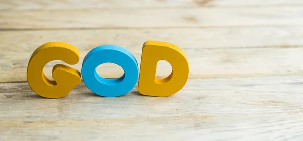Palabra de madera colorida Dios en el suelo de madera2 — Foto de Stock