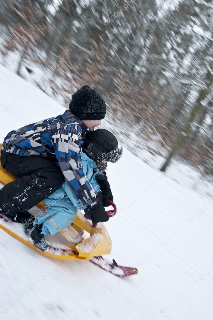 Racing downhills on a snow sledge
