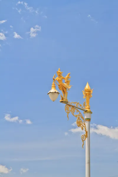 Half-bird half-woman on street lamp — Stock Photo, Image