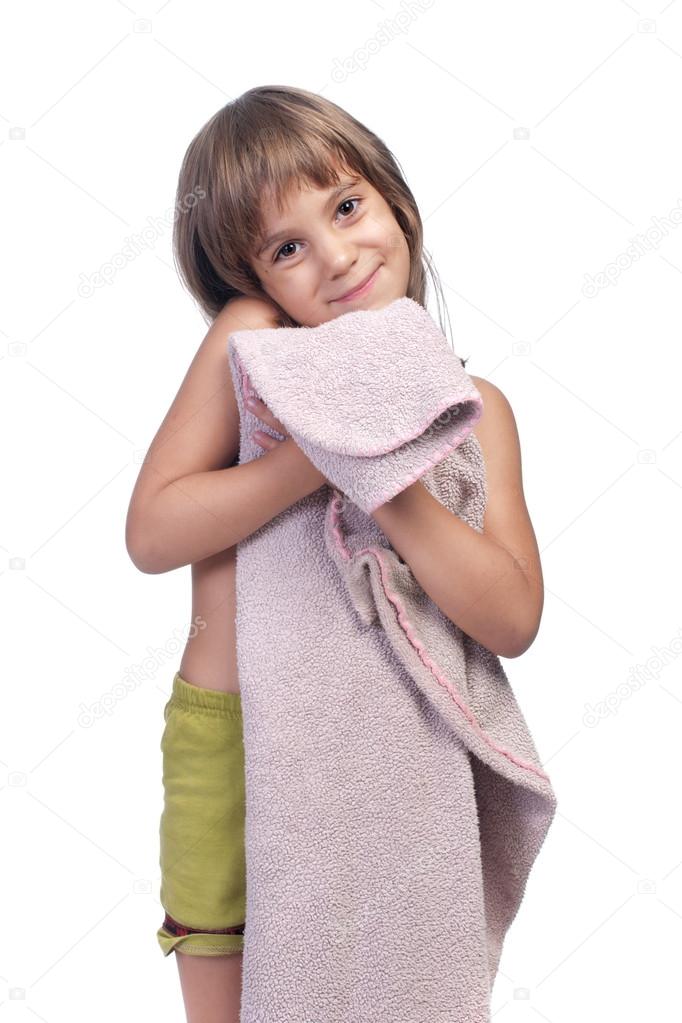Little girl, holding pink blanket, studio shot