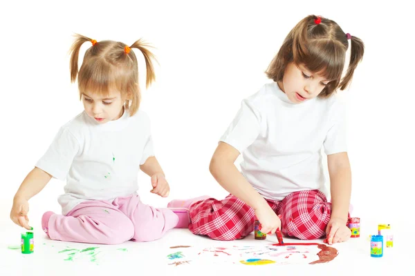 Two little girls painting (isolated on white background) Stock Photo