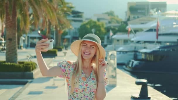 Ładna dziewczyna w kapeluszu robi selfie na smartfonie — Wideo stockowe