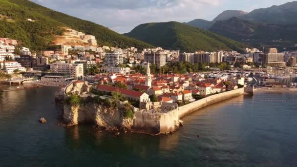 Historical part of the city washed by th sea from drone. Drone Shot of old town Budva in Montenegro. — стоковое видео