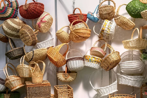 Empty wicker baskets in stock. Collection of various wicker baskets at the fair.