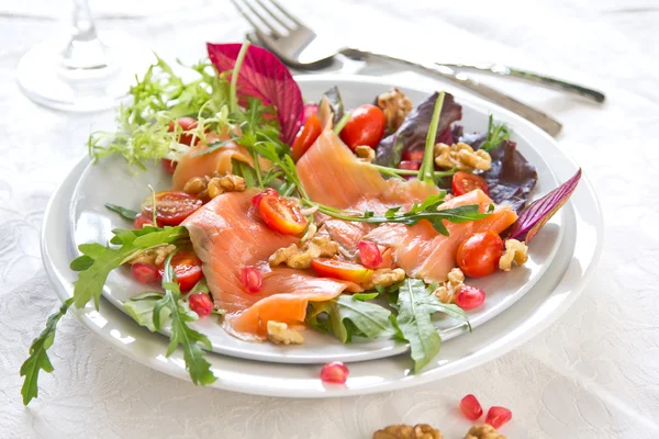 Smoked salmon with pomegranate salad — Stock Photo, Image