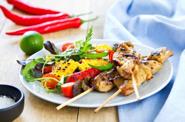Grilled chicken skewer with salad clipart