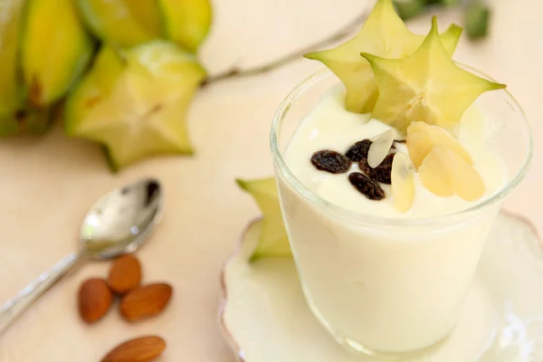 Yogurt with almond and starfruit — Stock Photo, Image