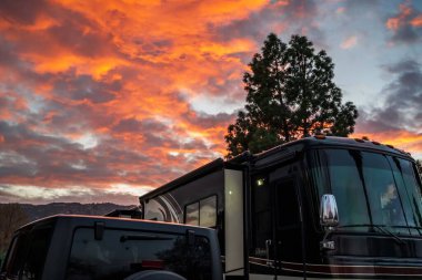 Lake Elsinore, CA, USA - Feb 9, 2021: The jeep and the RV parked along the park