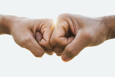 Yakın plan genç adam arka planda yumruk tokuşturma. Arkadaşlık ve Takım Çalışması Kavramı.