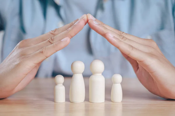 Man Hands Protect Wooden Peg Dolls Planning Saving Family Health — Stock Photo, Image