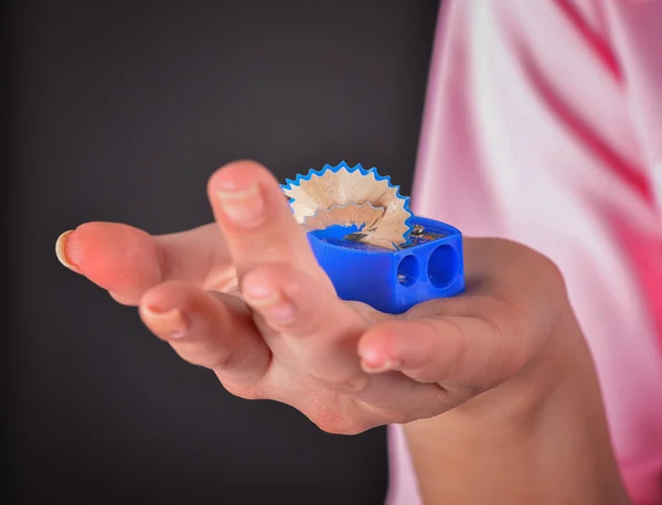 Hand with a blue sharpener — Stock Photo, Image