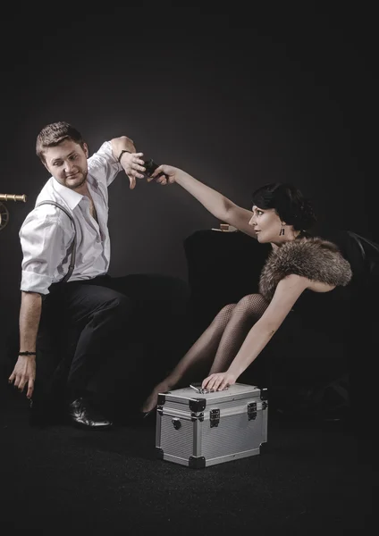 Girl aiming a gun in the guy — Stock Photo, Image