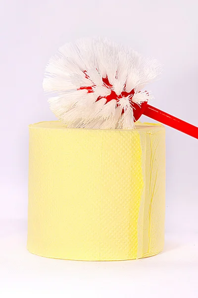 Yellow toilet paper and red brush — Stock Photo, Image