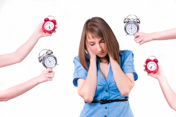 Girl and a lot of alarm clocks — Stock Photo, Image