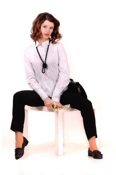 Girl sits with money in her hands — Stock Photo, Image