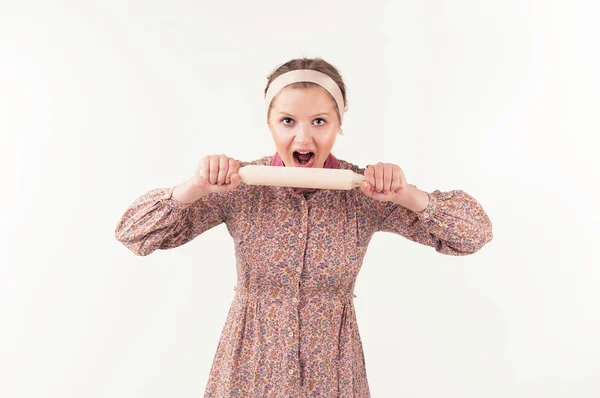 Girl gnaws a rolling pin for dough — Stock Photo, Image