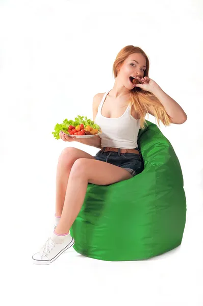 Girl eats a tomato — Stock Photo, Image