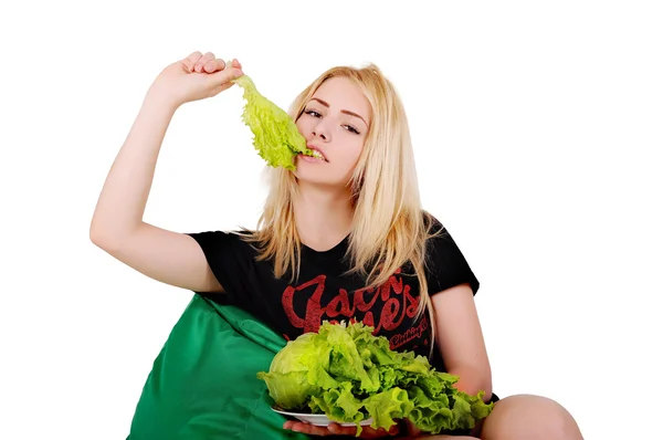 Girl biting a cabbage leaf — Stock Photo, Image