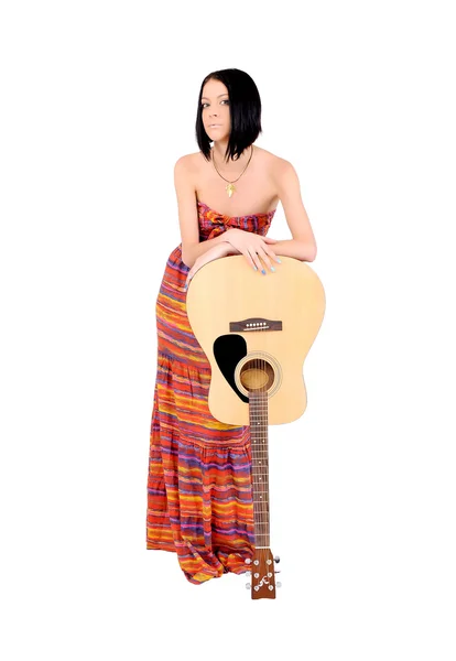 Girl in dress is leaning on a guitar — Stock Photo, Image