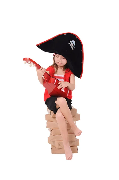 Girl in a costume sits on a stack of paper — Stock Photo, Image