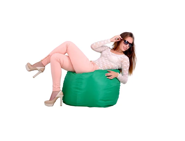 Girl lies on a green pufe — Stock Photo, Image