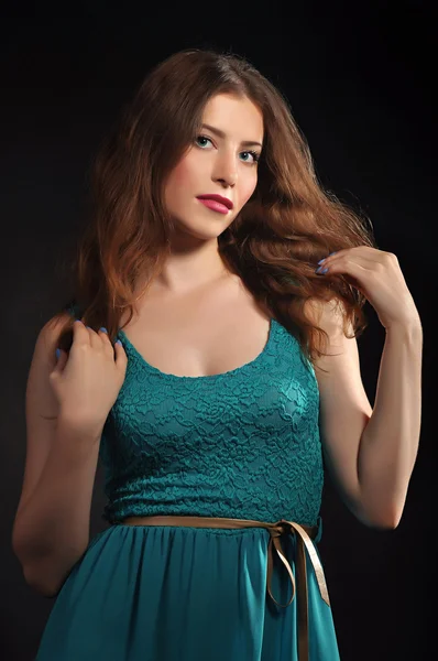 Beautiful girl in a turquoise dress — Stock Photo, Image