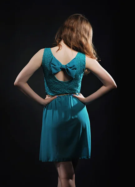 Girl in a dress with a bow, photo from behind — Stock Photo, Image