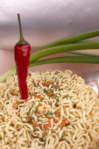 Noodles, hot chili and onions in dish — Stock Photo, Image