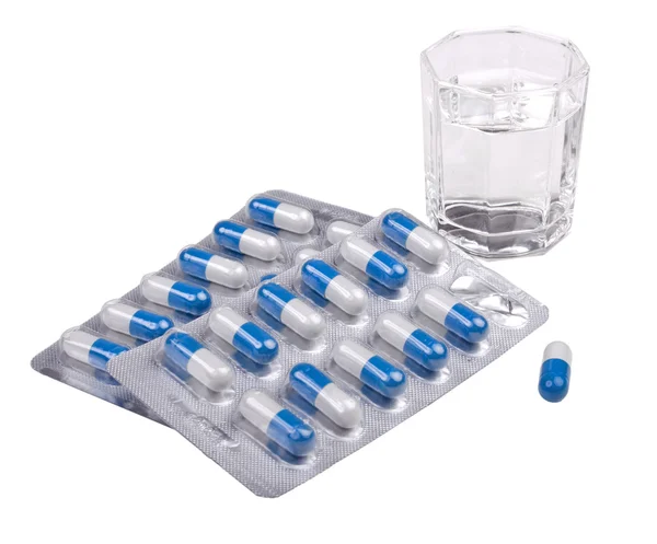 Tablets and glass of water — Stock Photo, Image