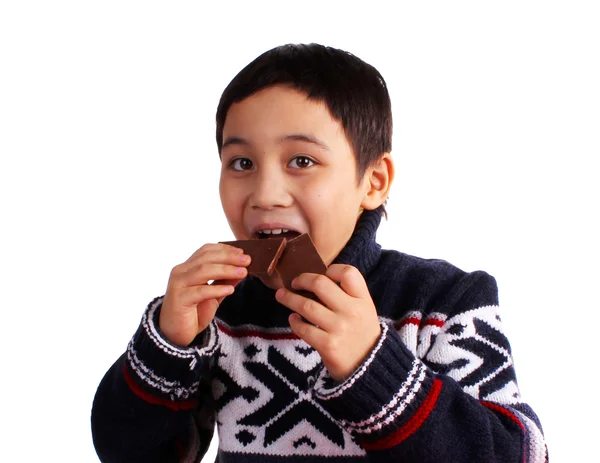 Boy is eating chocolates — Stock Photo, Image