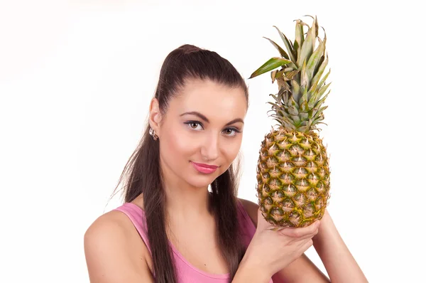 Het meisje houdt ananas — Stockfoto