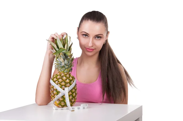 Girl holding pineapple with centimeter — Stock Photo, Image