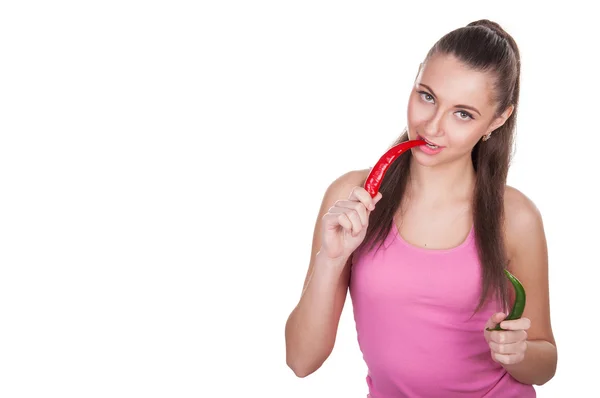 Chica mordiendo pimienta — Foto de Stock