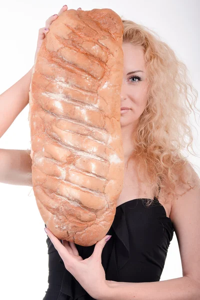 Girl eating a loaf of bread — Stock Photo, Image