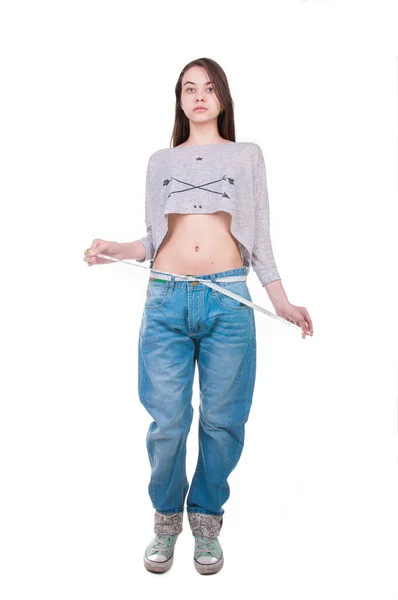 Menina bonita mostrando seus resultados de perda de peso — Fotografia de Stock