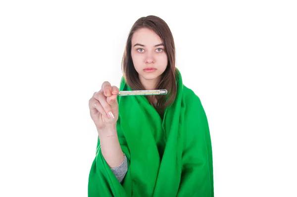 Ill woman covered with blanket holding a thermometer in her hand — Stock Photo, Image