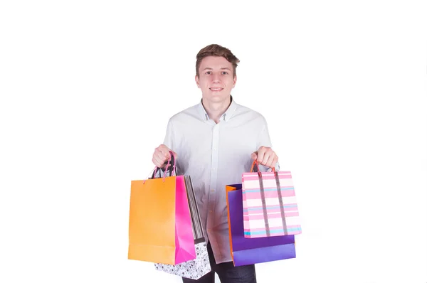 Young man with full of bags — Stock Photo, Image