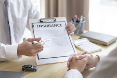 Selling cars, Car dealership or sales manager offers the sale of a car and explains the terms of signing a car purchase and insurance contract, Finance and after-sales service concept. 	