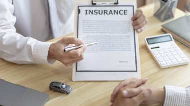 Selling cars, Car dealership or sales manager offers the sale of a car and explains the terms of signing a car purchase and insurance contract, Finance and after-sales service concept. 	