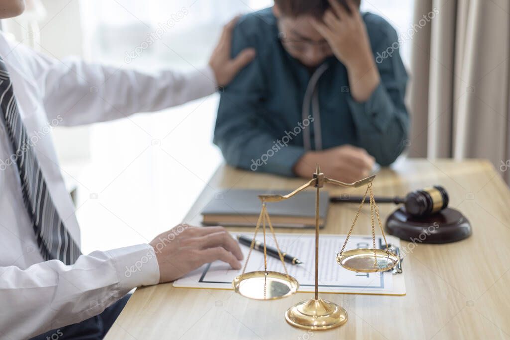 Prosecutor or lawyer comforts a client who is worried about a fraudulent business, Legal and Justice Litigation Assistance, legal consultant, scales of justice, law hammer, Litigation and justice.