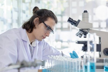 Sentetik maddelerin laboratuvar teşhisi, bilim adamı ya da araştırmacı tüp içinde bulunan maddeyi inceler ve laboratuvar deneyleri, test tüpü üzerinde çalışan bilim adamları.