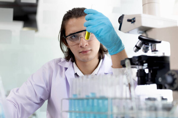 Laboratory diagnosis of synthetic substances, Scientist or researcher examines the substance in vitro and record information, Lab experiments, Researchers scientist working analysis with test tube.