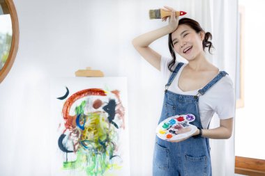 Female artist painting on canvas, Artist studio interior, Draw with watercolor, Drawing supplies , Painting and creativity, Use a brush to draw a pattern by stripes, Artwork, Using Paint Brush. clipart